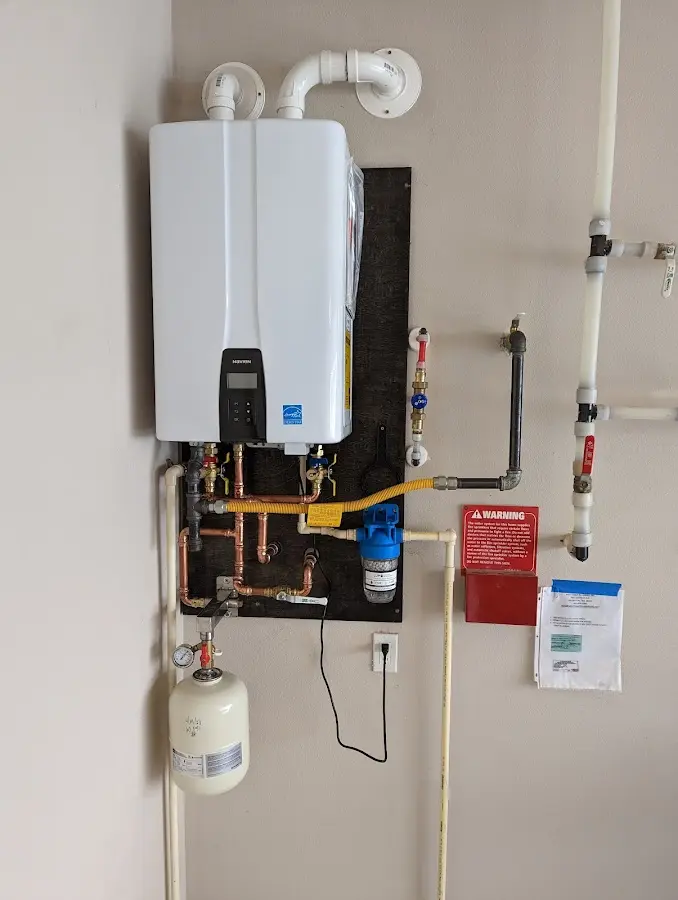 Professional plumber installing copper piping in a Fairview home